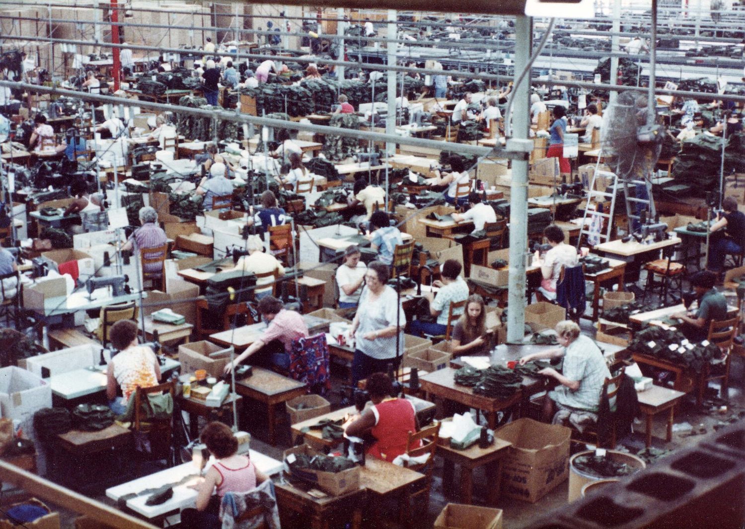 A garment factory floor full of workers at sewing machines