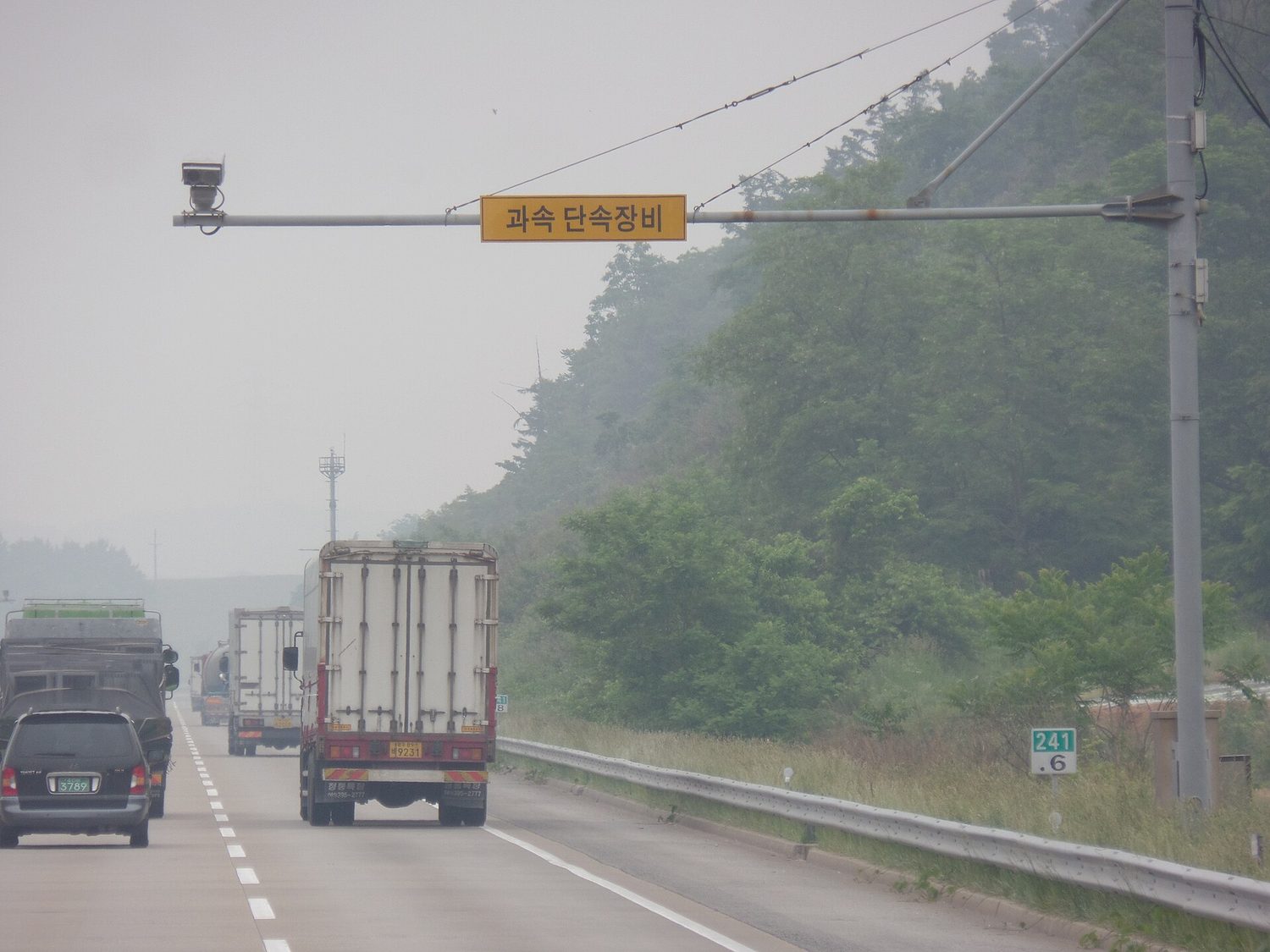 An average-speed enforcement camera on a gantry over a motorway