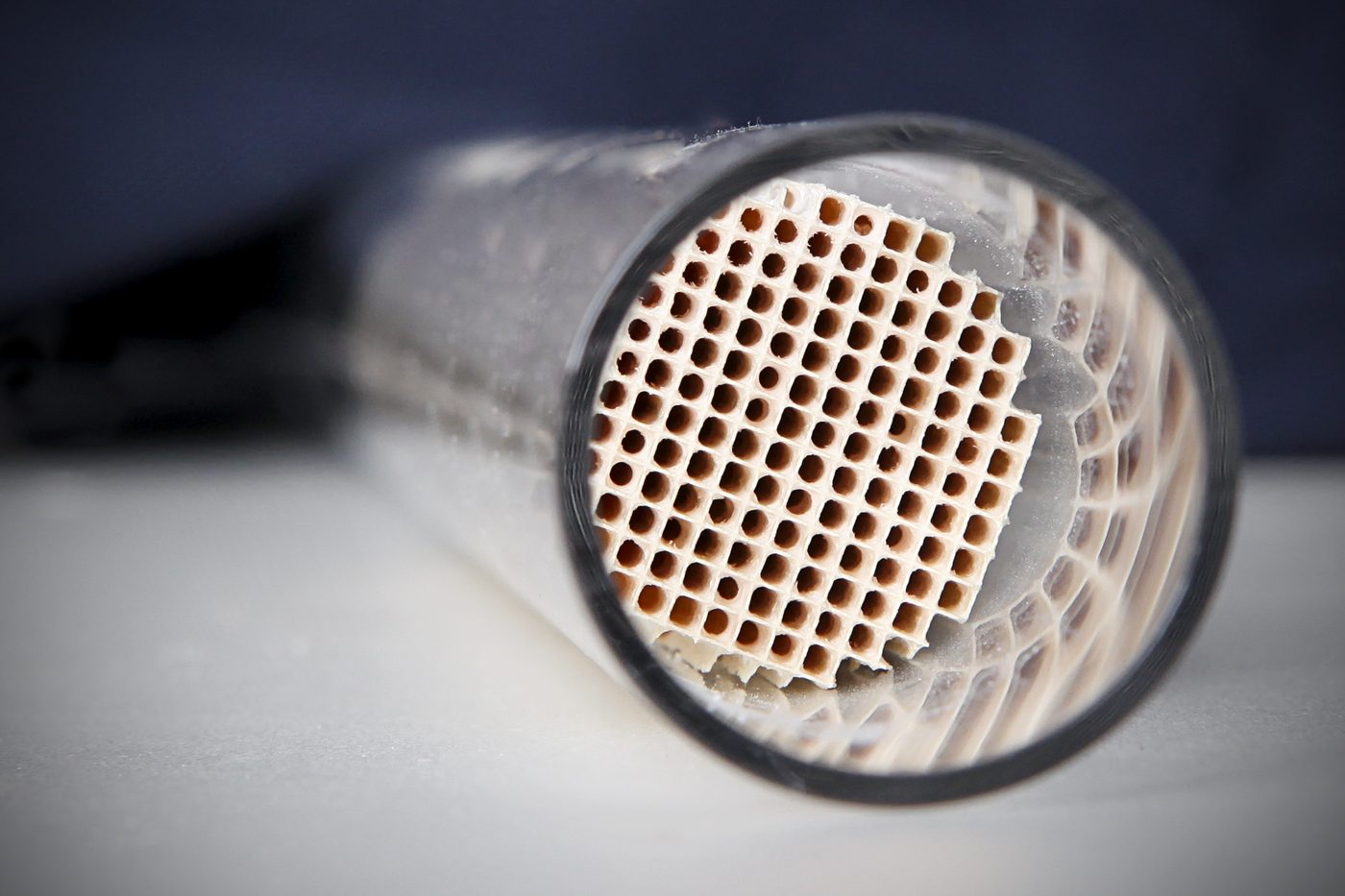 A catalytic converter: catalysts speed rates by lowering activation energy without being consumed