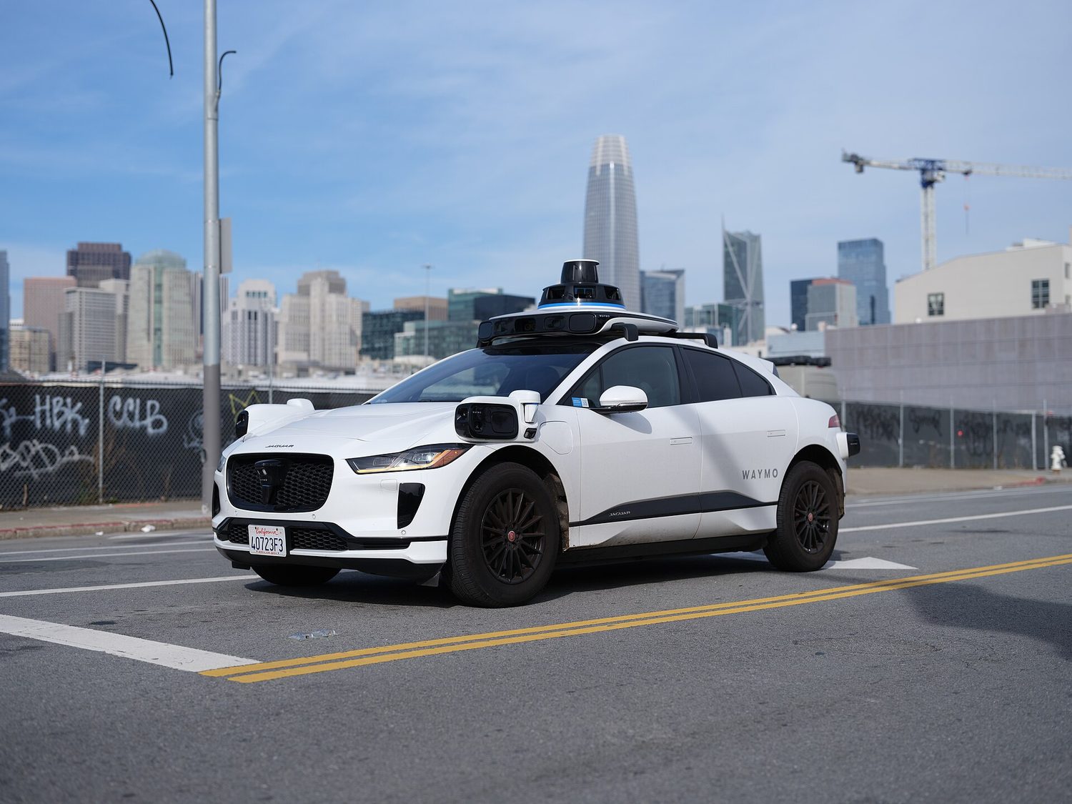 A self-driving car on a city street — autonomous systems raise safety and bias questions