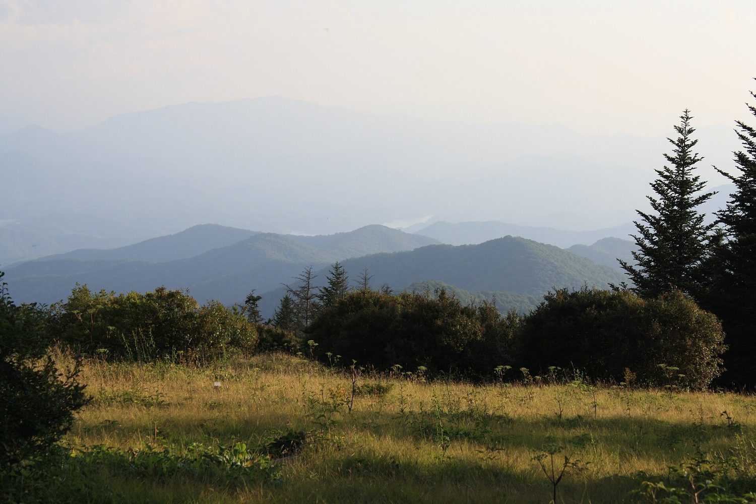 Layered mountain ridges fade with distance: atmospheric perspective cools and lightens far forms