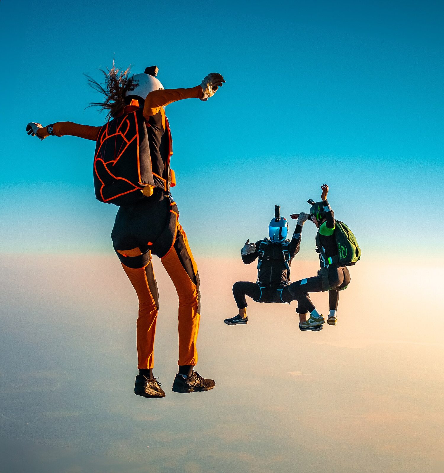 A skydiver: free-body diagrams balance gravity and air resistance at terminal speed