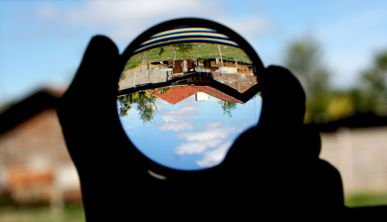 A magnifying glass showing an upside-down image behind it