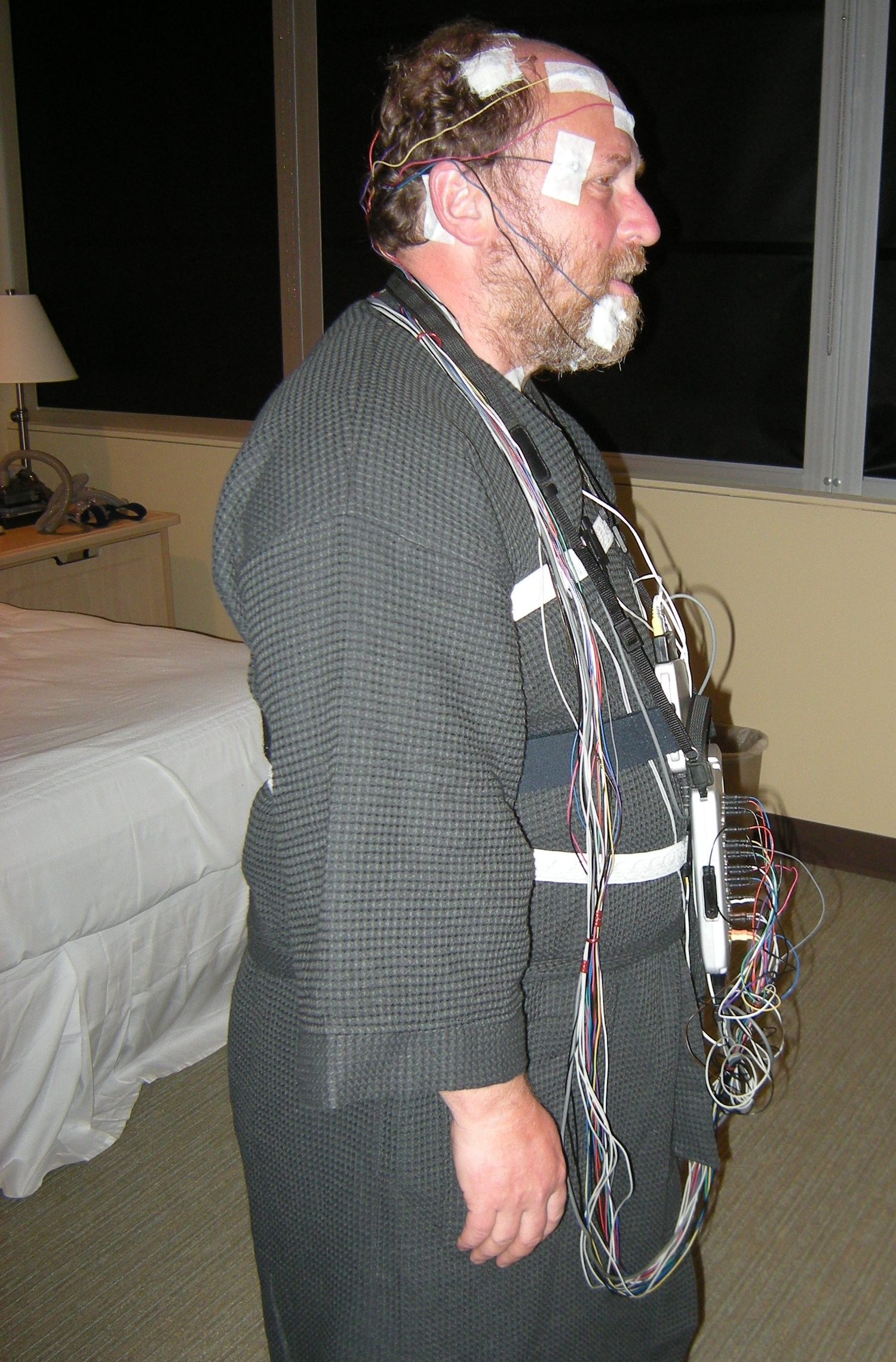 A participant wired for polysomnography - this is what measuring sleep stages actually looks like