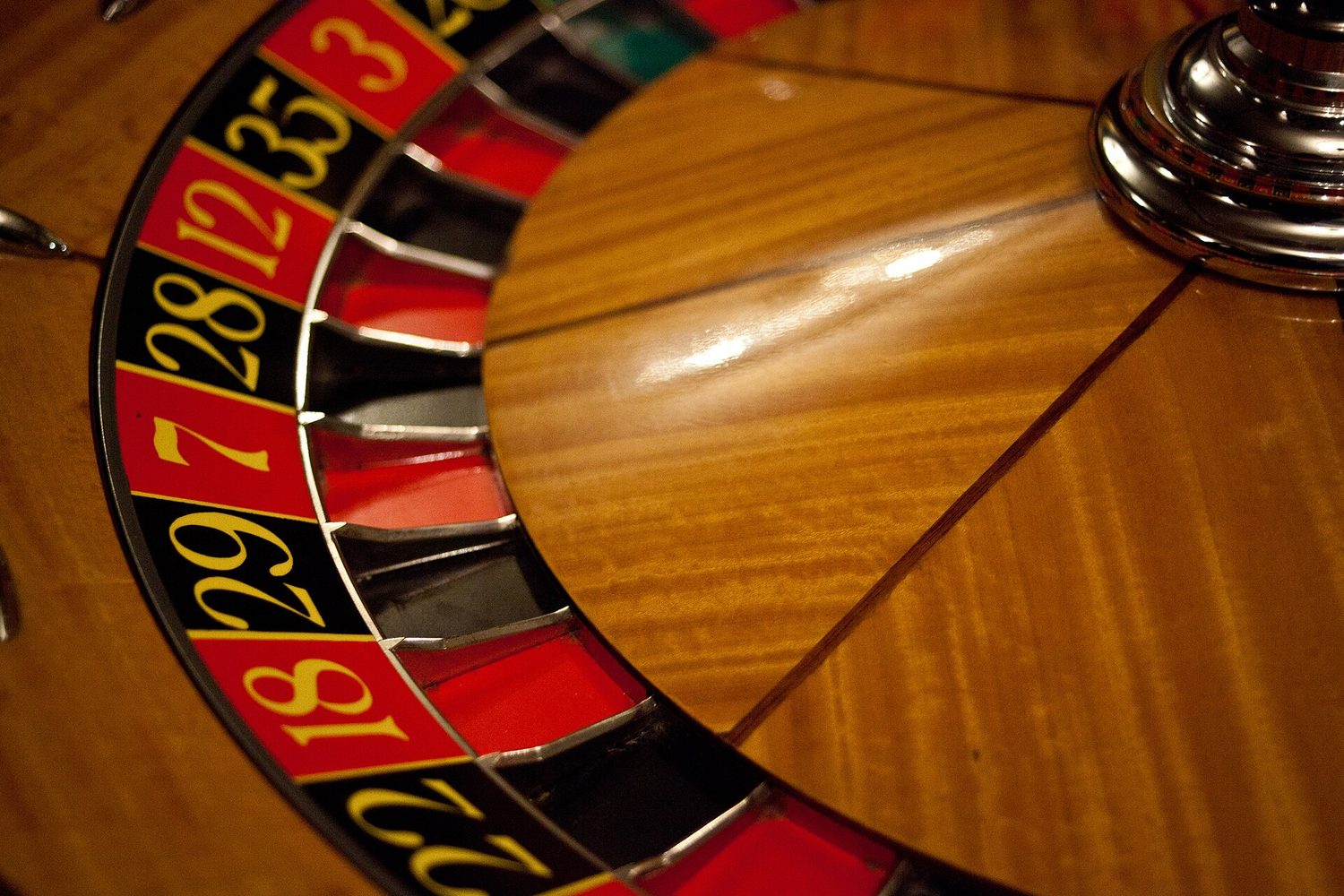 A roulette wheel, its numbered pockets all the same size around the rim